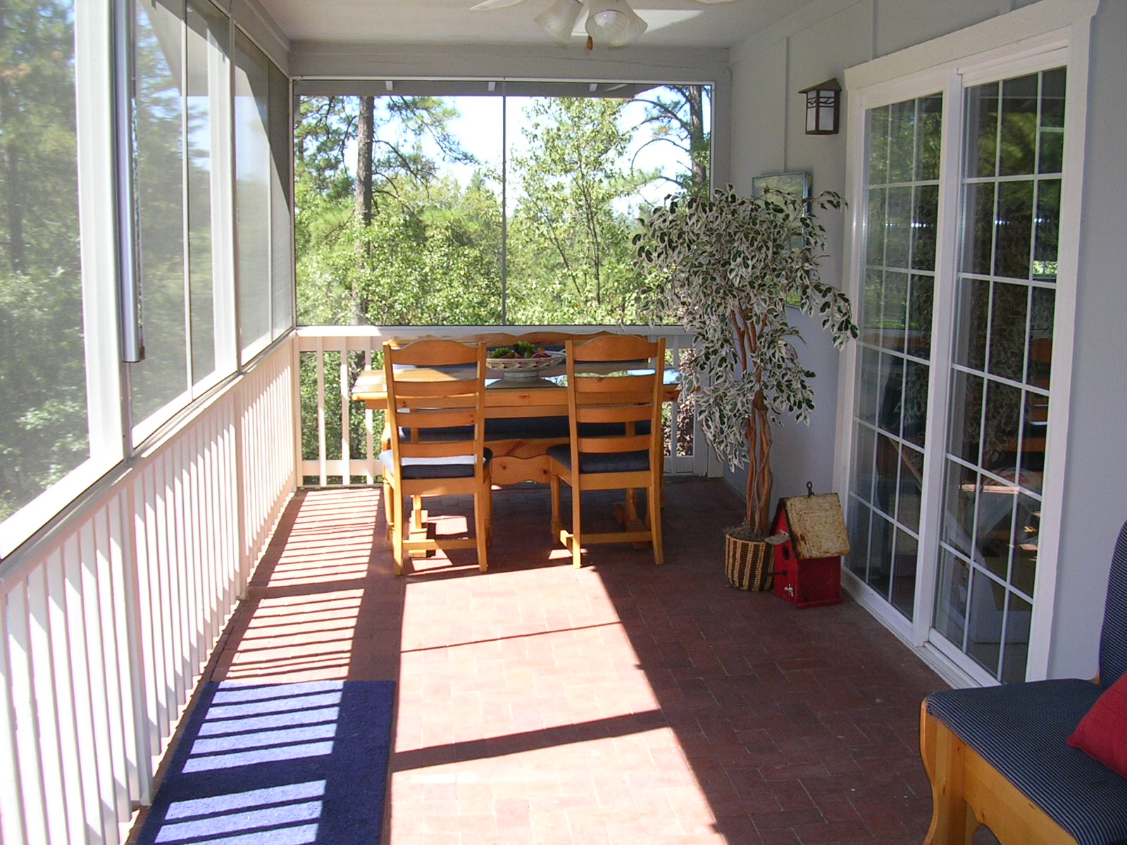 Enjoy dinners on this screened in porch.