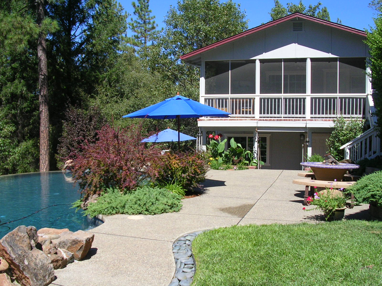 Rear exterior of home, with pool.